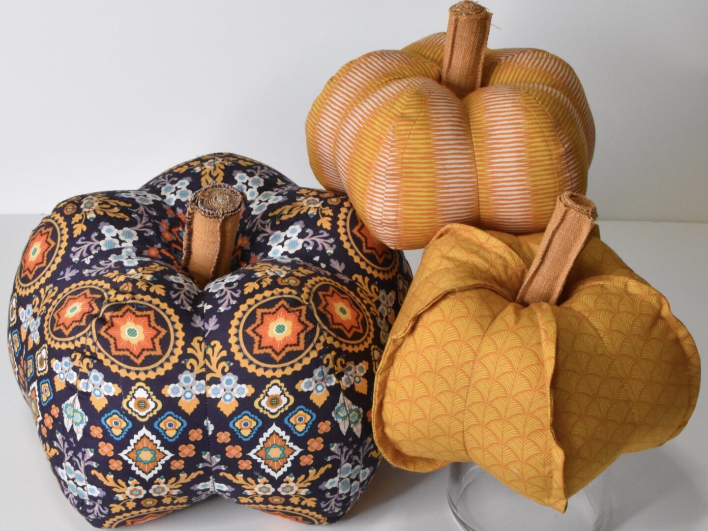 three fabric pumpkins