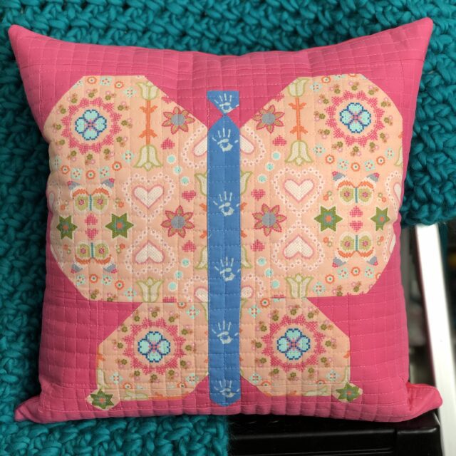 A pink butterfly pillow