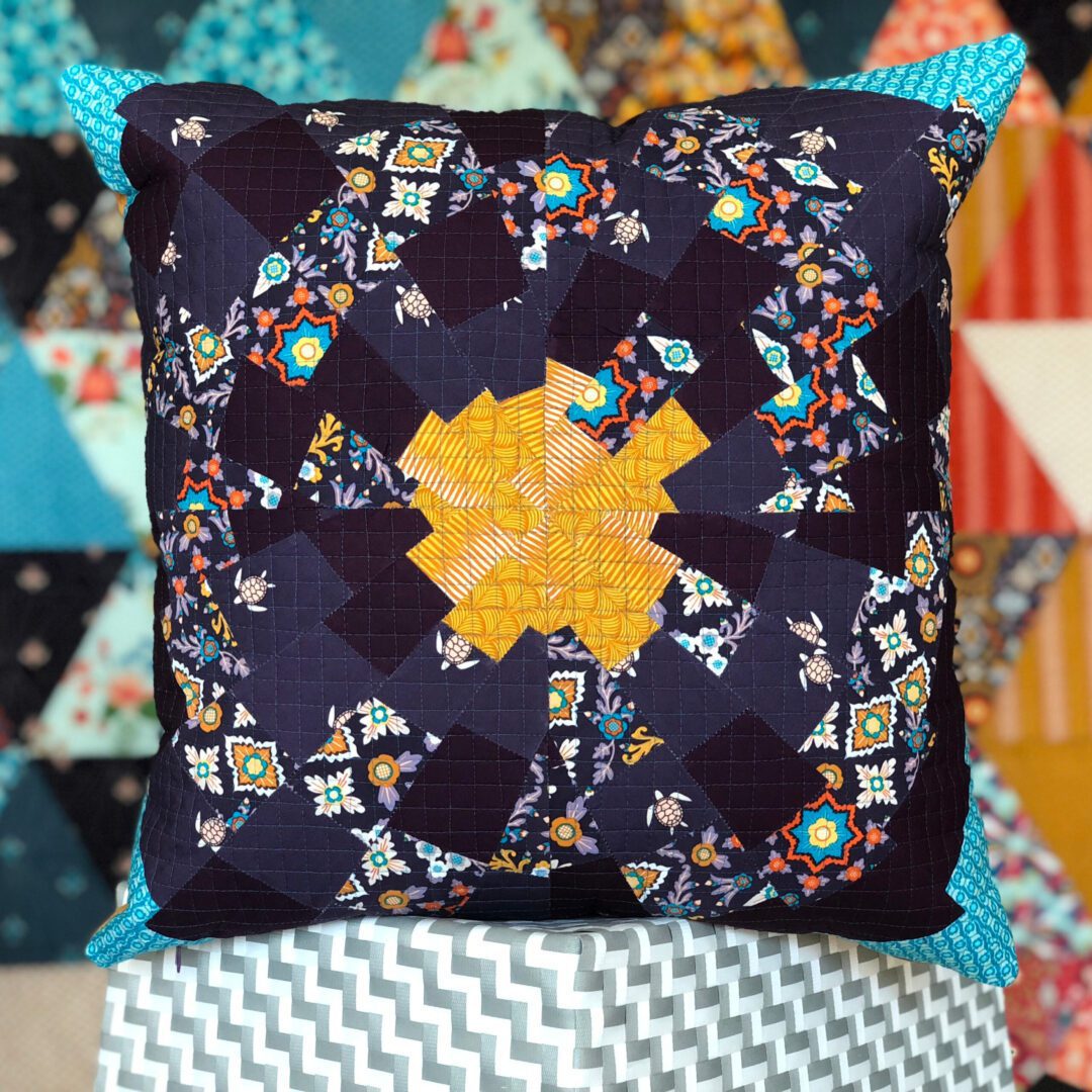 black pillow with colorful pattern and blue tips